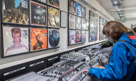 A customer browses vinyl records in a shop in London