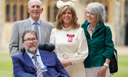 Kate Garraway with Derek Draper and her parents, Gordon and Marilyn Garraway, in June 2023 after being awarded an MBE for her services to broadcasting, journalism and charity.