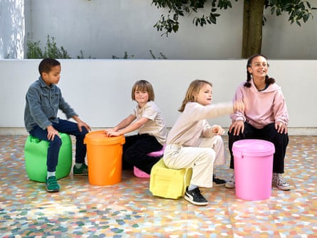 Children sitting on and playing with Rachel Whiteread’s Untitled (Canister) series (2024–) - casts of everyday objects including buckets and water carrier.