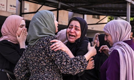 The mother of Ahmad Ramzi Sultan, a 20-year-old Palestinian, is comforted as she mourns him after he was killed during an Israeli army raid.