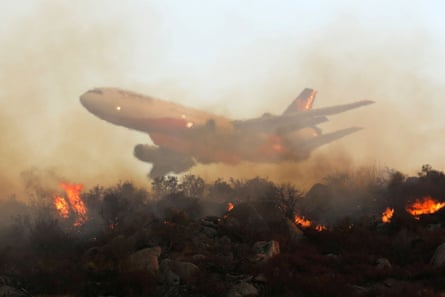 A plane drops retardant over a wildfire, Hemet, California, US