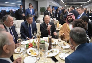 At half-time there’s no sign or a pie or a mug of Bovril as Russian President Vladimir Putin, Saudi Crown Prince Mohammed bin Salman and other guests chow down