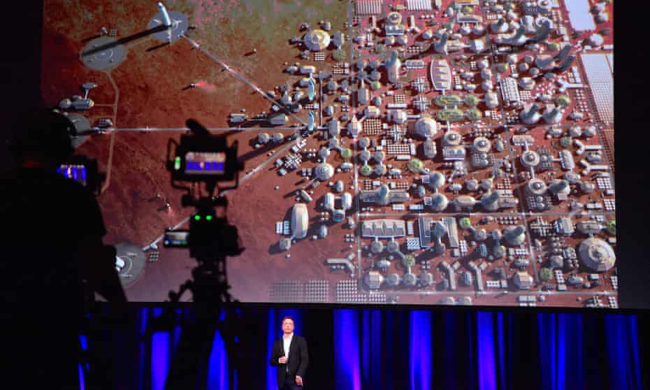 Elon Musk, founder of SpaceX, during a presentation at the International Astronautical Congress in Adelaide. On screen: a depiction of a human colony on the planet Mars.