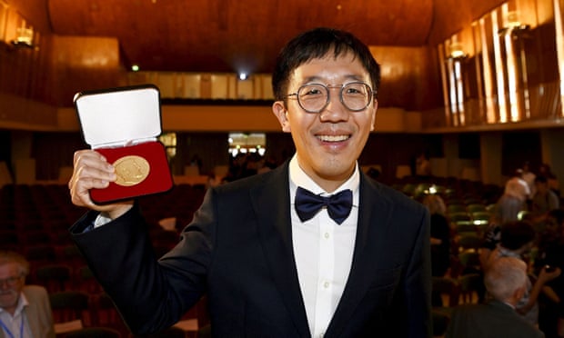 Fields medal for mathematics awardee June Huh poses with his medal.