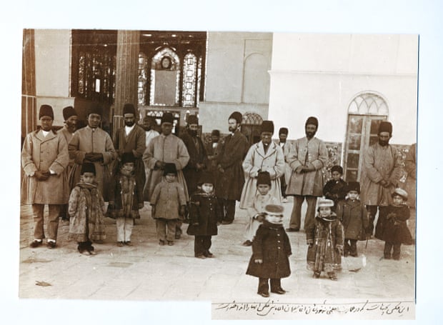 Based on the caption written by Masoud Mirza Zell-e-Soltan, the photographer of this image was his chief slave, Aqabaji. In this picture four of Zell-e-Soltan’s adult African slaves are seen keeping an eye on his children, Chehel Sotun Palace, Isfahan. 1890s