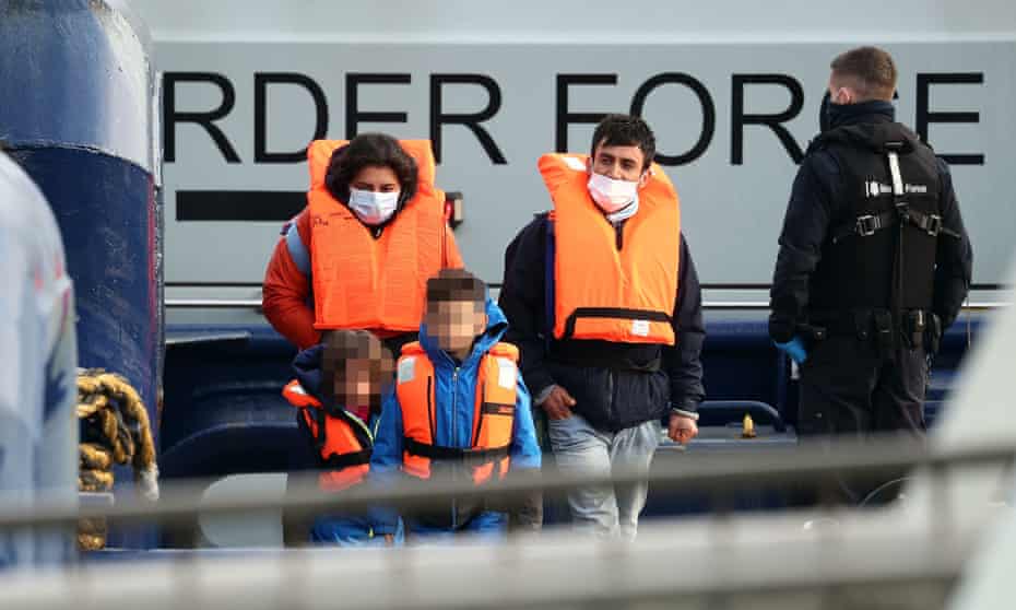 A family thought to be migrants are brought in to Dover, Kent, by Border Force officers.