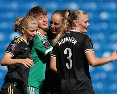 The Aston Villa goalkeeper Akane Okuma (second left) is embraced by three of her teammates, including the defender Mathilde Harviken (right), after her team's 1-1 draw away at Chelsea in the Women's Super League.