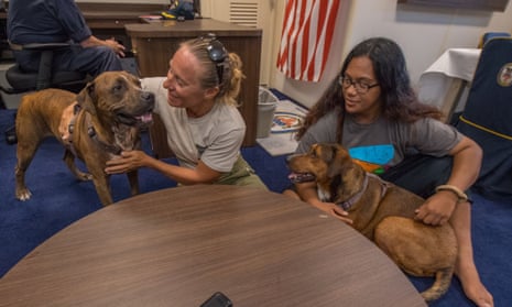 Jennifer Appel, left, and Tasha Fuiava, with their dogs Zeus, left, and Valentine, take questions in the captain’s cabin of the USS Ashland. 