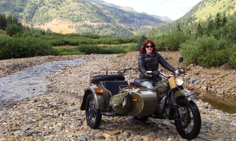 Lois Pryce crossing the Colorado river on one of her many long-distance bike adventures.