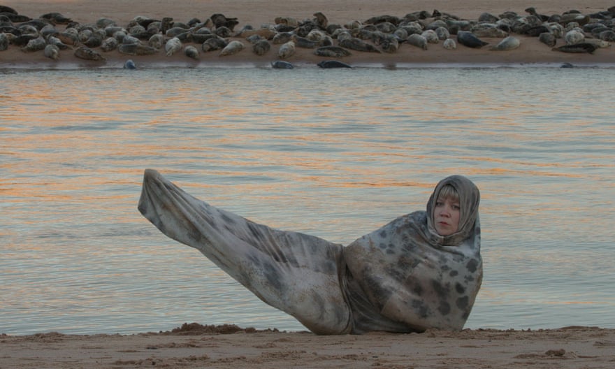 Tuulikki in seal costume by water for the film Seals’kin (2022).