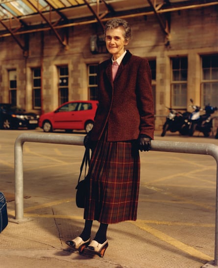 Image from The British Isles by Jamie Hawkesworth of an older woman leaning against a bike rack.