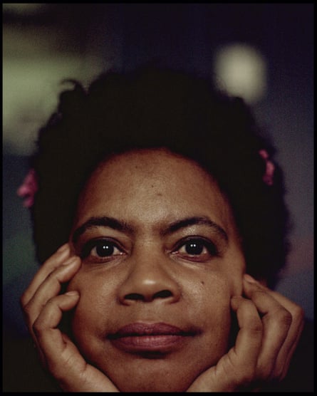 K’Sisay Sadiki sits with her chin resting on her hands.