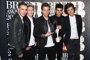 Liam Payne, Niall Horan, Louis Tomlinson, Zayn Malik and Harry Styles of One Direction pose with their Brits global success award in the press room at the 2013 Brit awards