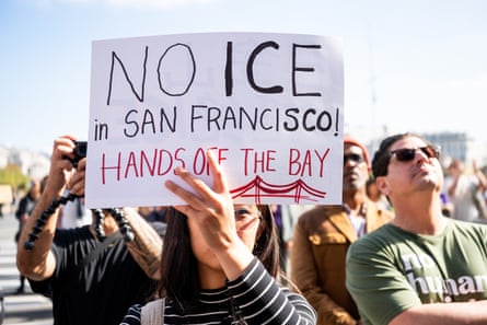 A protester holds a sign outside city hall in San Francisco on Thursday.