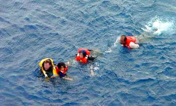 Unidentified Australian sailors help to rescue children swimming in the sea near Australia in what became known as the ‘children overboard’ affair.