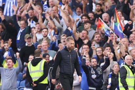 Chelsea manager Graham Potter looks dejected as the Brighton fans celebrate.