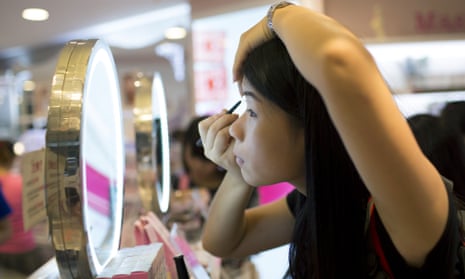 Chinese girl applying eyeliner