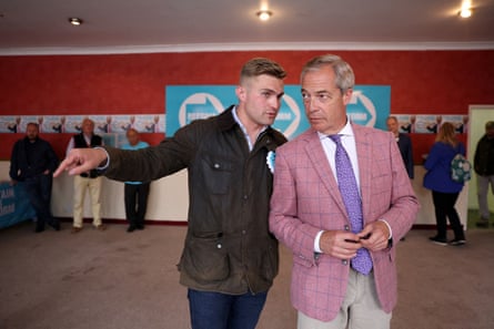 Dan Jukes, wearing a wax jacket, talks to Farage