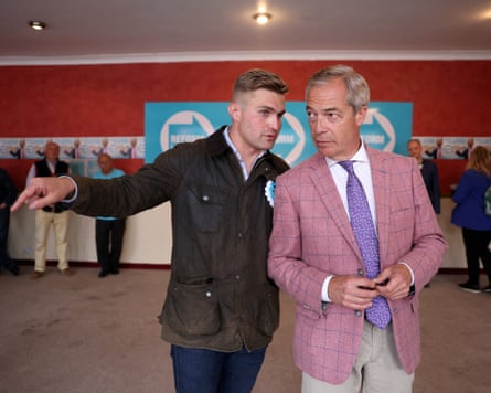Nigel Farage and Dan Jukes speak to each other at a Reform event in Clacton