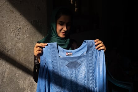 Fashion designer Hasina Aimaq with her version of the blue burqa commonly worn by Afghan women.
