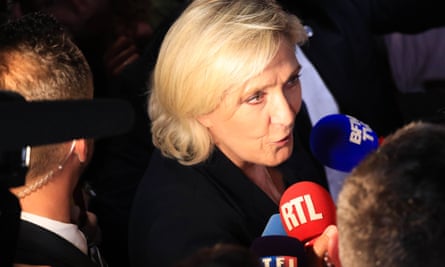 Le Pen speaks into media microphones