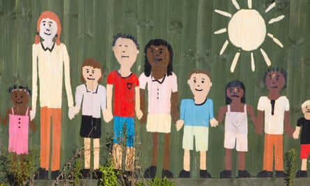 Painted figures children on nursery school fence wall.