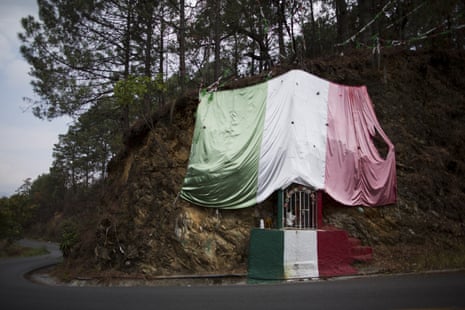 A shrine to the Virgin of Guadalupe is decorated with a Mexican flag on the road leading to Filo de Caballos
