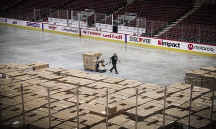 A worker moves food onto the floor of the United Center in Chicago, Illinois, on 20 March.