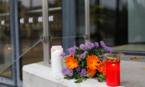Flowers and candles are seen at the doors of the Uppsala Concert and Congress Hall after the deaths.