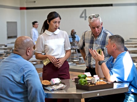 two group opinionated talk to men sitting astatine tables successful beforehand of repast trays