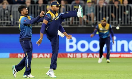Sri Lanka's Dasun Shanaka kicks the ball as he takes a successful catch to dismiss Australia's David Warner