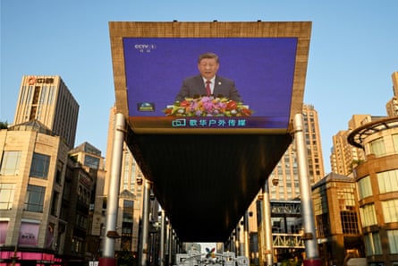 A giant outdoor screen shows China’s president Xi Jinping speaking