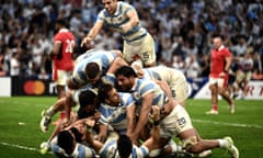 Argentina's players mob Nicolás Sánchez after he dived in to score their decisive late try.