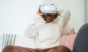 Young woman at home wearing VR glasses