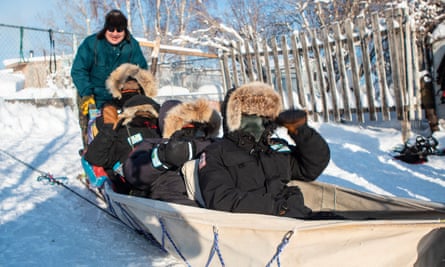 Australian rangers dogsledding with Steve Nitah (at the back) Dene traditional owner and local conservation and development leader. Dog sledding was a key means of transport for traditional owners. Yellowknife, Canada.