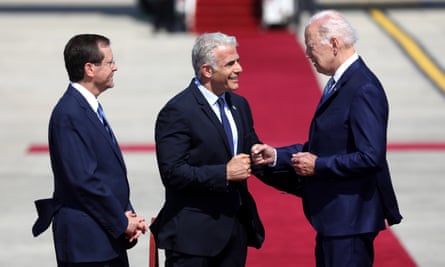 Joe Biden fist bumps with the Israeli prime minister, Yair Lapid, as the Israeli president, Isaac Herzog, looks on.
