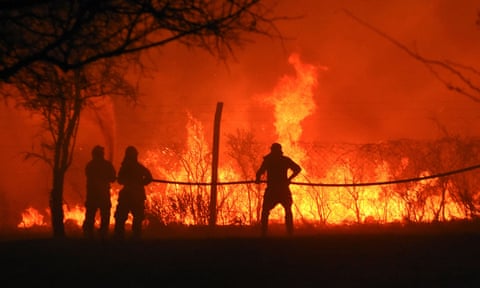 Firefighters tackle a blaze in San Antonio de Arredondo, Córdoba province, Argentina, September 22, 2020. 