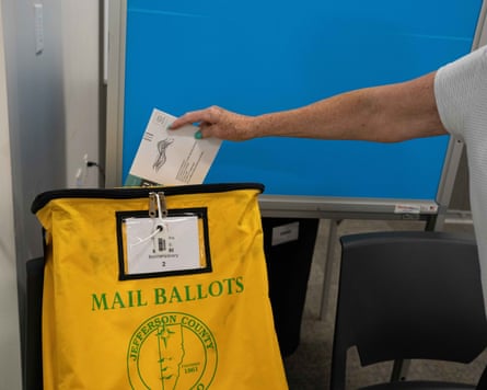 A female casts a mail-in superior predetermination ballot.