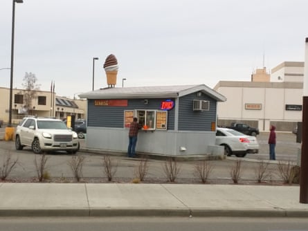 a person in front of a coffee hut