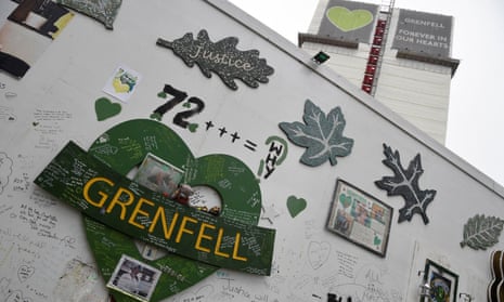 Messages of condolence are seen on temporary hoardings and on the covered remains of the Grenfell Tower.