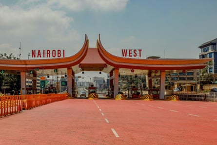 Motorists drive through a toll station