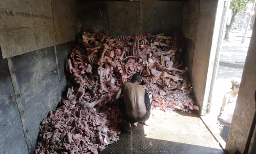 A man scavenges through animal carcasses for food amid a growing hunger crisis in Brazil in the wake of the Covid-19 pandemic.
