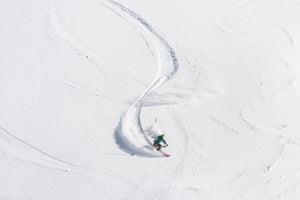 Above view of a freeride skier making a sharp turn in fresh powder snow.2014509