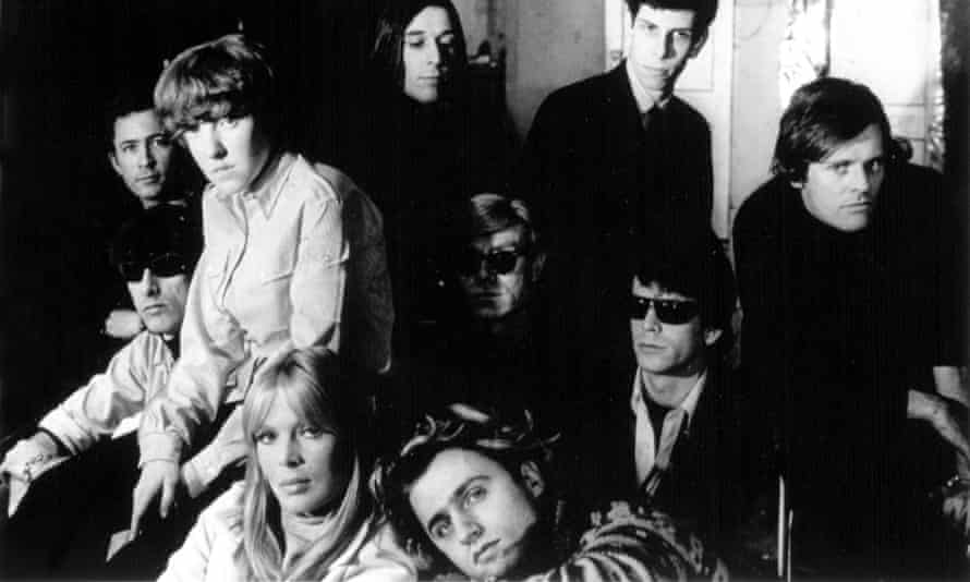 Andy Warhol (centre) between John Cale and Lou Reed with members of the Velvet Underground and Factory star Paul Morrisey (far right).