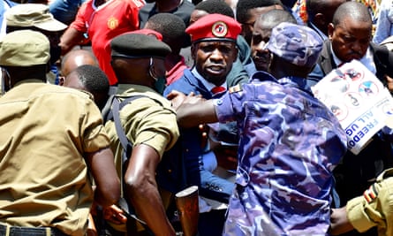 The Ugandan opposition leader and singer Robert Kyagulanyi, known as Bobi Wine, is detained during an anti-government demonstration in Kampala in 2021