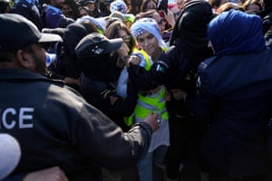 Activists from the socialist-feminist organisation Women Democratic Front scuffle with female police officers during a rally