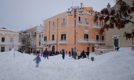 People walk through the snow in Santeramo in Colle in the Puglia region of southern Italy.