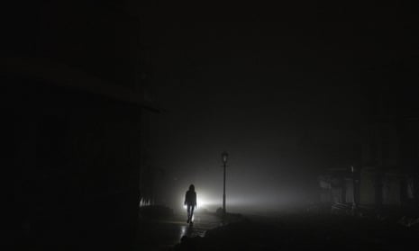 A woman walks in Kyiv city centre on Thursday which lost electrical power following a Russian rocket attack.