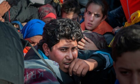 Anxious refugees crammed on to a small boat