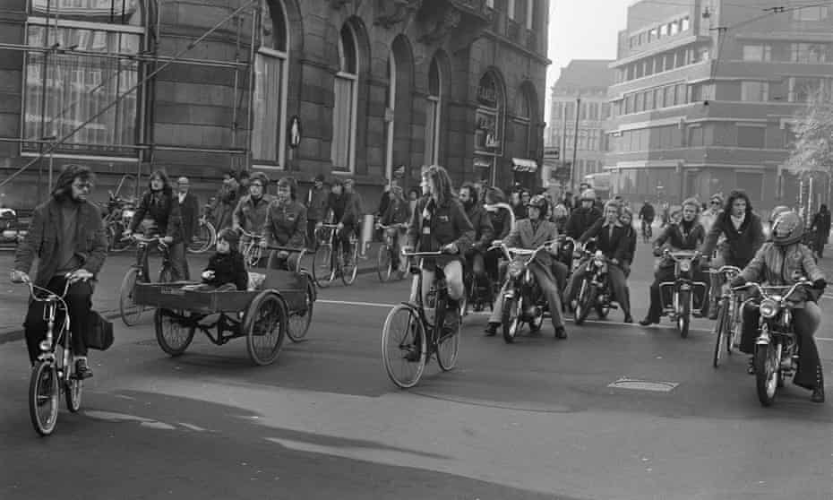 Cyclists, moped riders and a cargo bike on a car-free crossing, Amsterdam, 1973. 